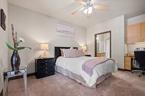 a bedroom with a bed and a ceiling fan a bedroom with a bed and a ceiling fan at The Millennium Towne Center Apartments, Louisiana